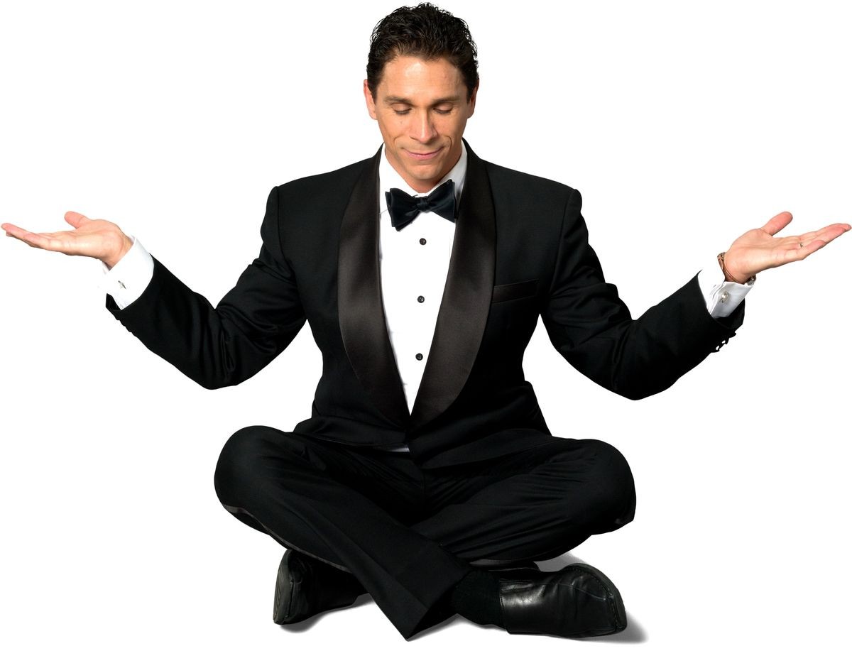 Optimistic Caucasian man with short black hair in a tuxedo with meditation hands - Isolated